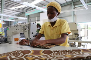 Garment factory worker in Rwanda making a coat for fashion brand KISUA. 70% of the workforce in the fashion supply chain are women